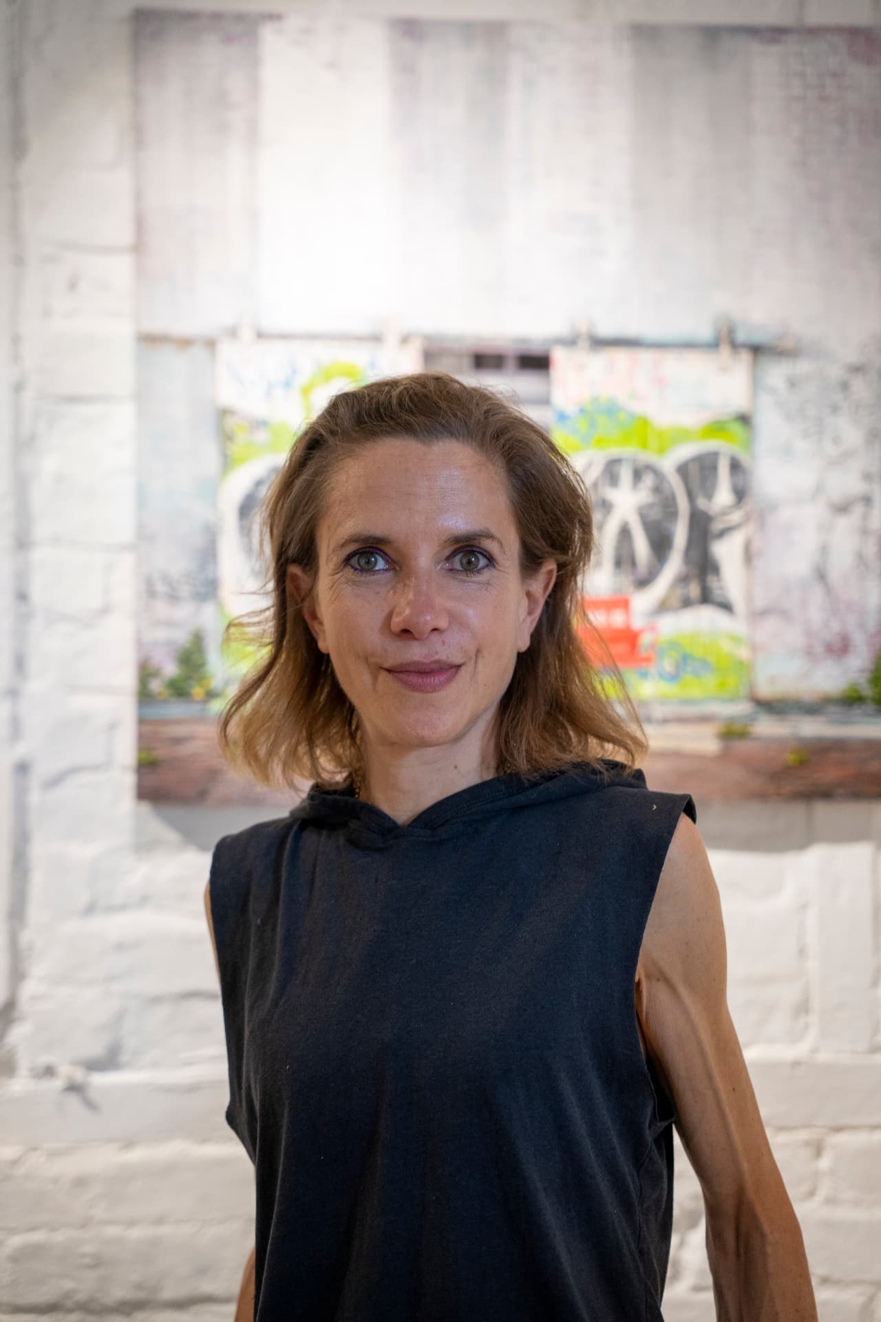 Portrait of Miranda Donovan in front of her work
